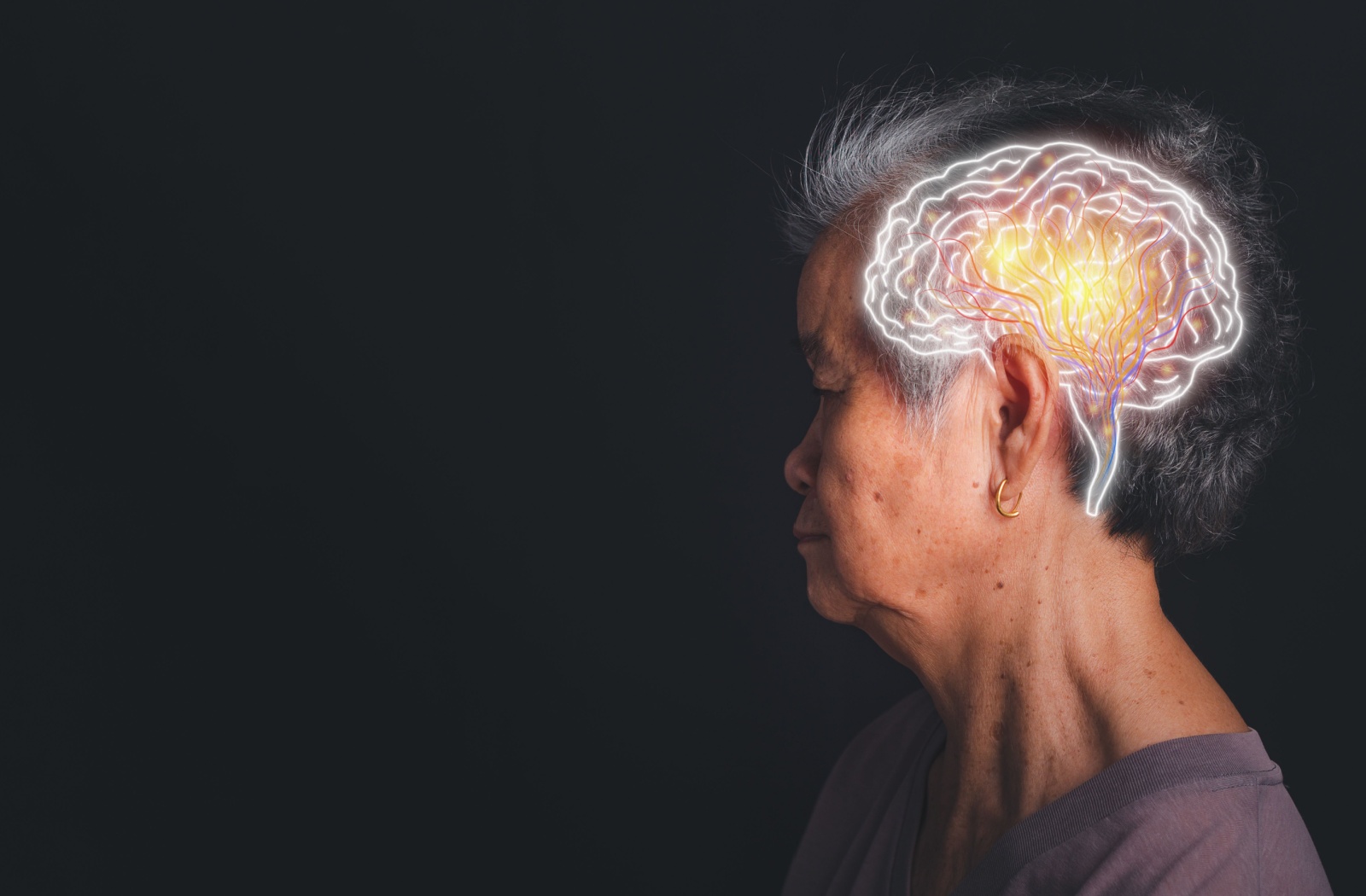 Against a dark backdrop, a senior looks to the left, with an image of brain activity superimposed on their head.